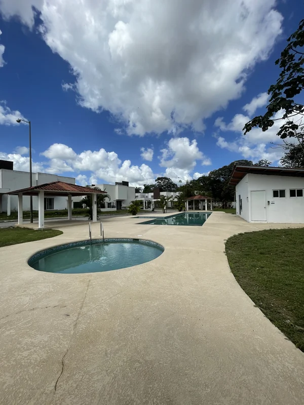 The pool with the homes behind